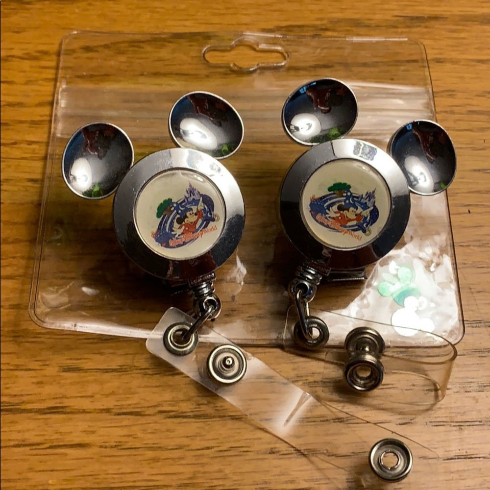 Two Disney lanyards with one plastic id pouch
